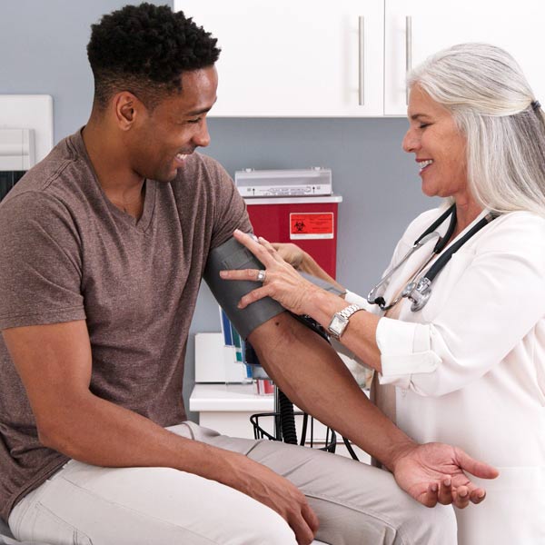 Photo of a man getting his blood pressure taken